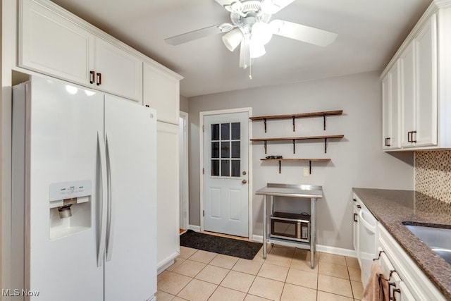 kitchen featuring white cabinetry, light tile patterned floors, white appliances, and decorative backsplash