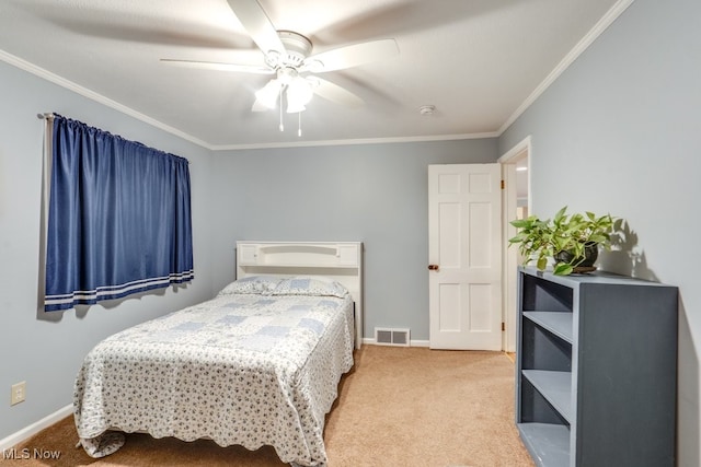 bedroom with carpet floors, ornamental molding, and ceiling fan