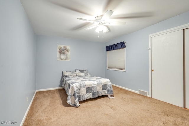 carpeted bedroom with a closet and ceiling fan