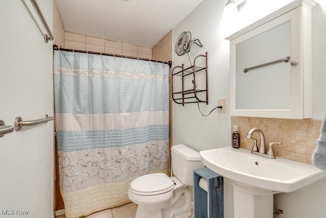 bathroom featuring sink, decorative backsplash, curtained shower, and toilet