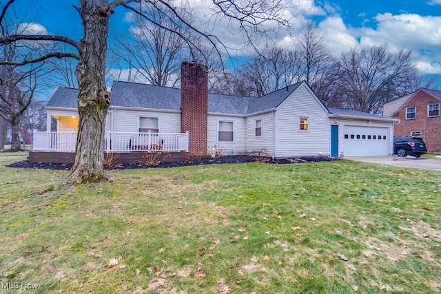 ranch-style home with a garage, a front yard, and a porch