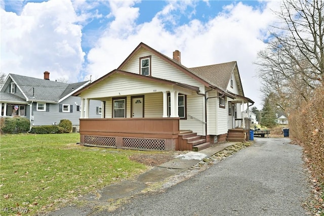 bungalow with a porch and a front yard