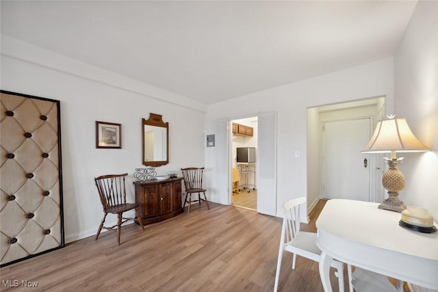 dining area with light hardwood / wood-style floors