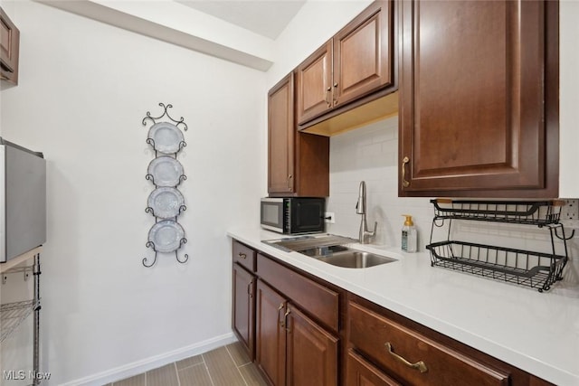 kitchen featuring tasteful backsplash and sink