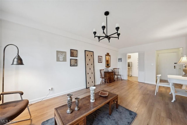 living room with an inviting chandelier and wood-type flooring