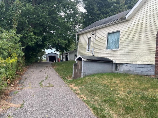 view of side of home with a garage and a yard