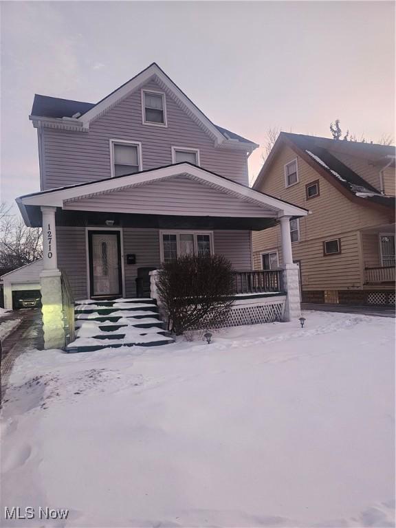 view of front of house featuring a porch and a garage