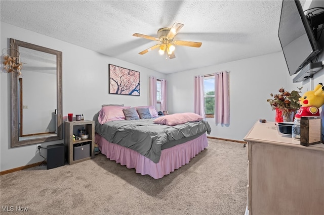 bedroom featuring light carpet, baseboards, and a textured ceiling