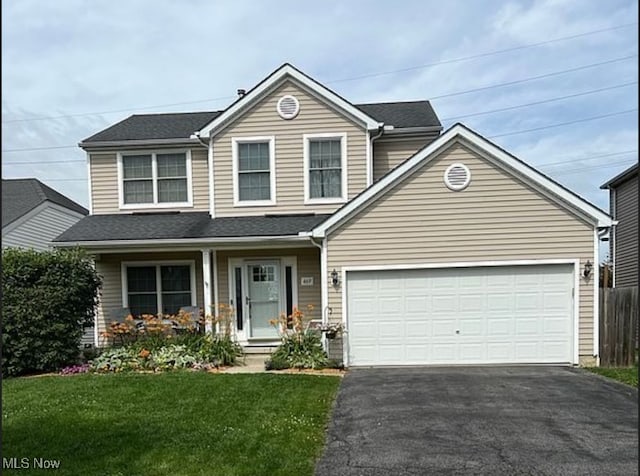 view of front facade featuring a garage and a front yard