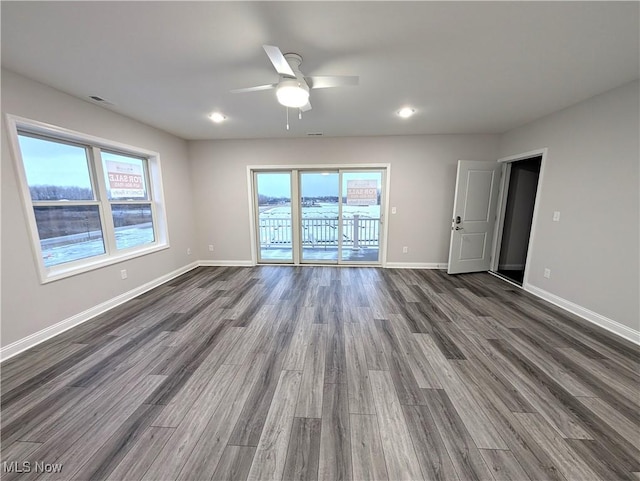 unfurnished room with dark hardwood / wood-style floors and ceiling fan