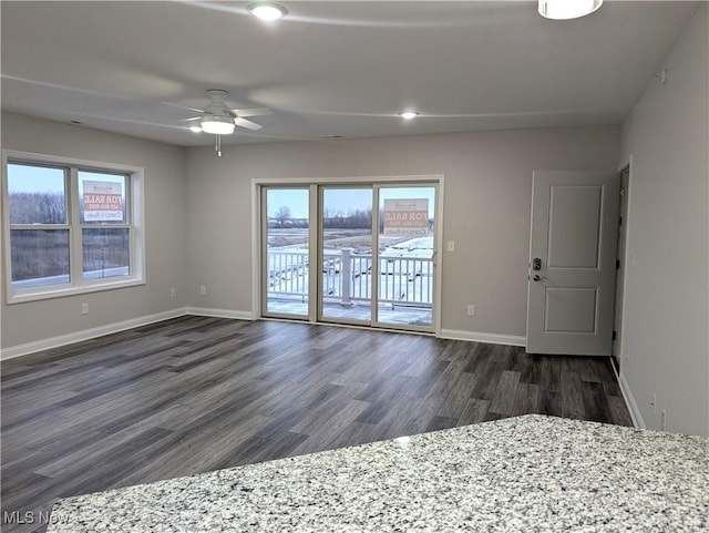 unfurnished room featuring dark hardwood / wood-style floors and ceiling fan