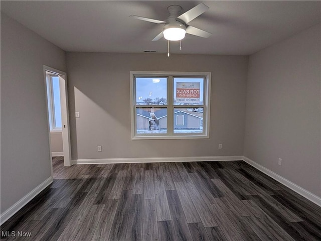 unfurnished room with dark hardwood / wood-style flooring and ceiling fan