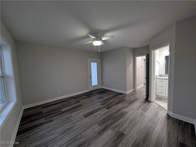 empty room featuring ceiling fan and dark hardwood / wood-style floors