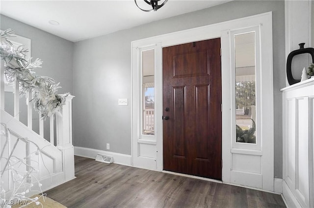 entryway with dark hardwood / wood-style flooring