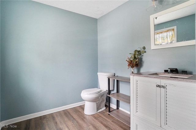 bathroom with vanity, hardwood / wood-style floors, and toilet