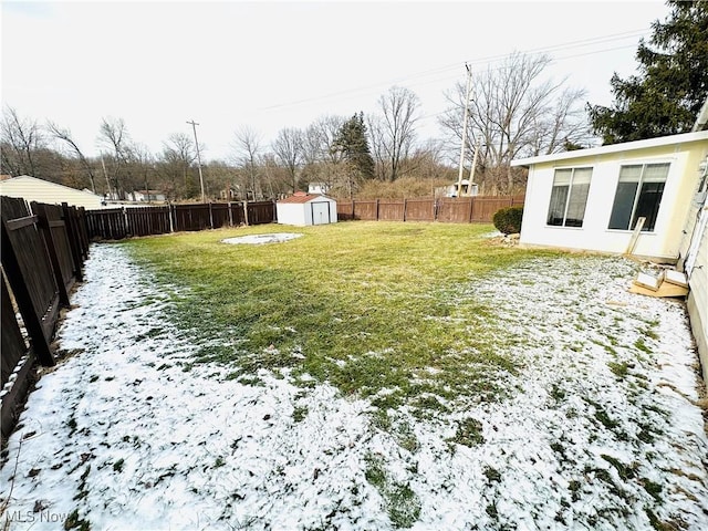 snowy yard with a storage shed