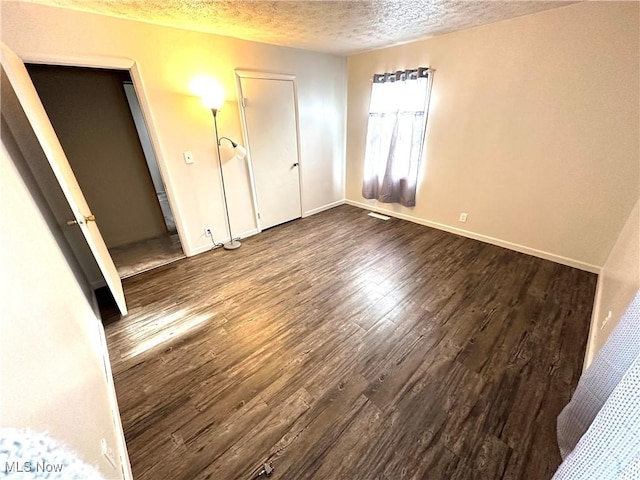 unfurnished bedroom with wood-type flooring and a textured ceiling