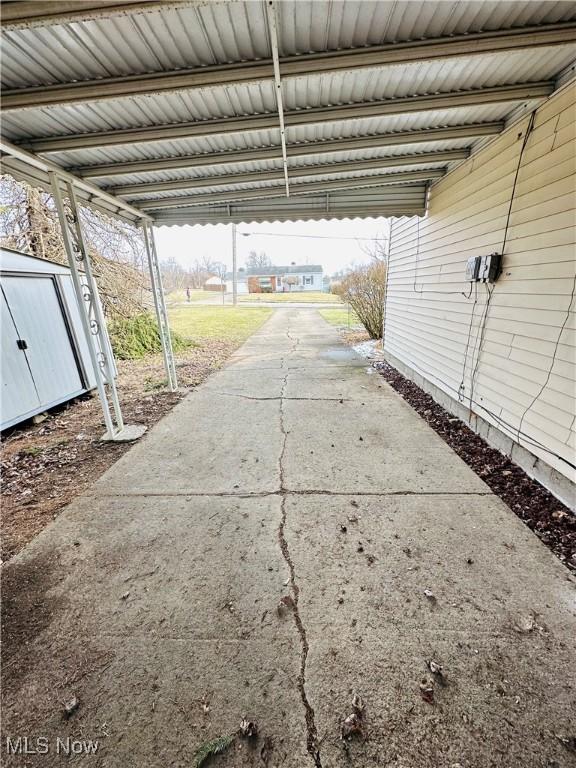 exterior space featuring a carport and a storage shed