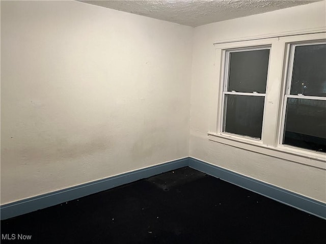 empty room featuring a textured ceiling