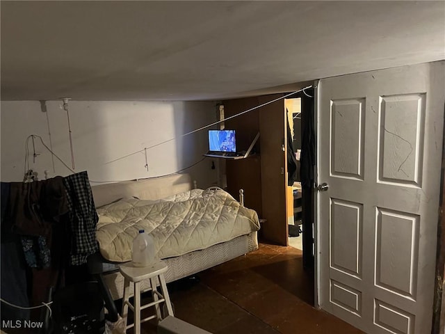 bedroom with dark wood-type flooring