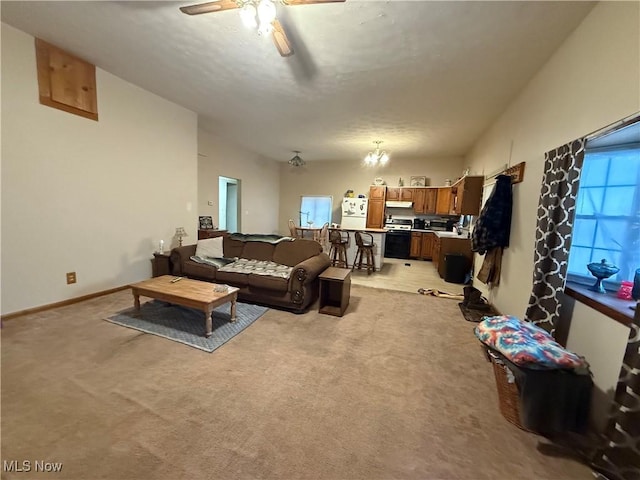 carpeted living room with a wealth of natural light and ceiling fan