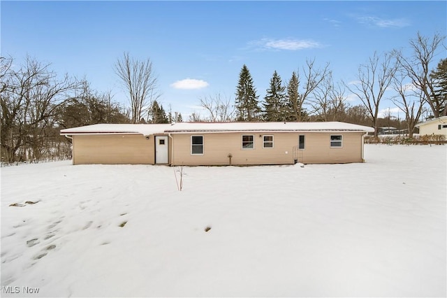 view of snow covered rear of property