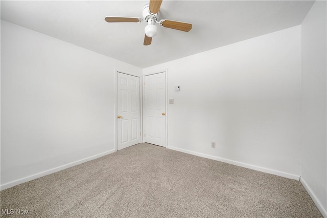 carpeted empty room featuring ceiling fan