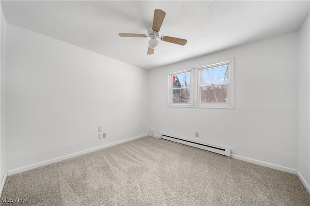 spare room featuring a baseboard heating unit, ceiling fan, and carpet