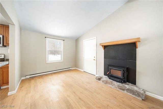 unfurnished living room featuring baseboard heating, vaulted ceiling, and light hardwood / wood-style flooring