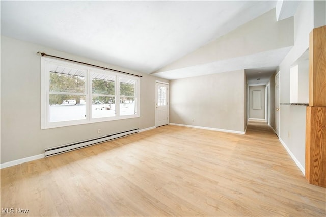 empty room featuring lofted ceiling, a baseboard heating unit, and light hardwood / wood-style floors