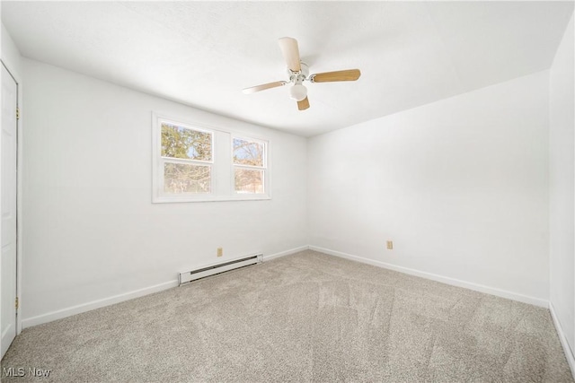 empty room featuring ceiling fan, carpet, and a baseboard heating unit