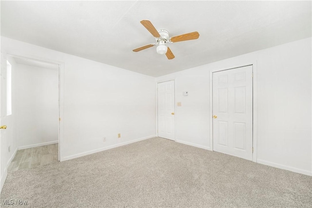 unfurnished bedroom featuring light colored carpet and ceiling fan