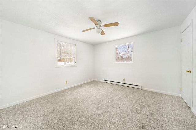 empty room featuring ceiling fan, carpet floors, and a baseboard heating unit