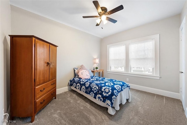 bedroom with ceiling fan and dark colored carpet