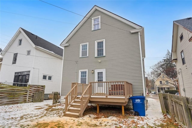 rear view of property featuring a deck