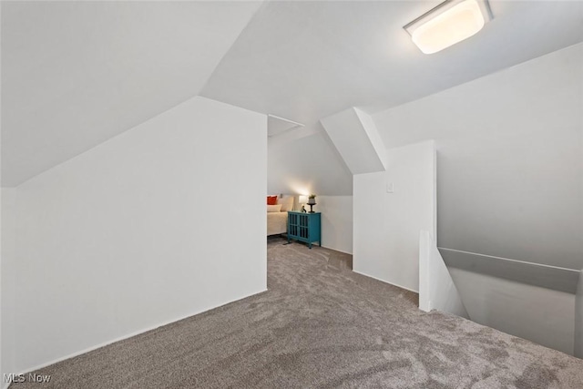 bonus room with carpet floors and vaulted ceiling