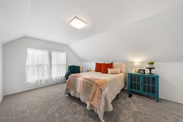 carpeted bedroom with vaulted ceiling