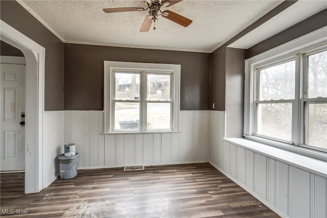 spare room with ceiling fan, a healthy amount of sunlight, hardwood / wood-style floors, and a textured ceiling