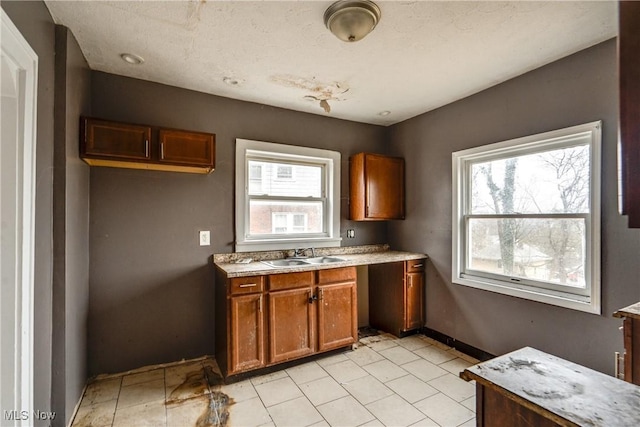 kitchen featuring plenty of natural light, sink, and a textured ceiling