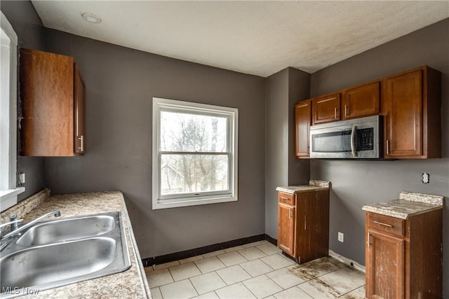 kitchen with sink and light tile patterned floors