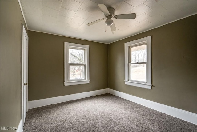 carpeted empty room with crown molding, ceiling fan, and plenty of natural light