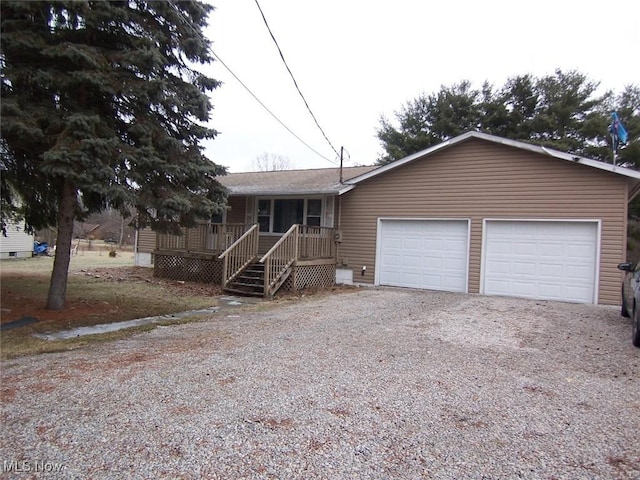 view of front of house with a porch and a garage