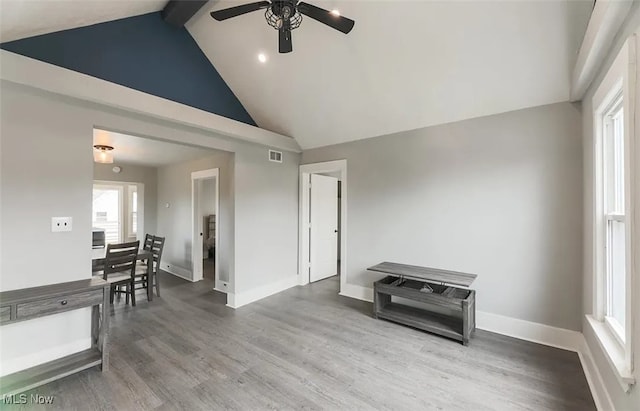 interior space with hardwood / wood-style floors, beam ceiling, high vaulted ceiling, and ceiling fan