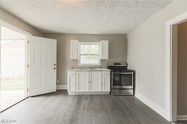 kitchen with white cabinetry, sink, dark wood-type flooring, a textured ceiling, and stainless steel electric range