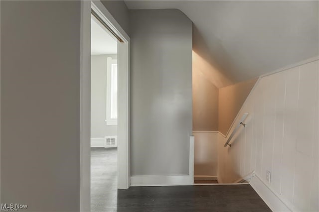 staircase with lofted ceiling and hardwood / wood-style floors