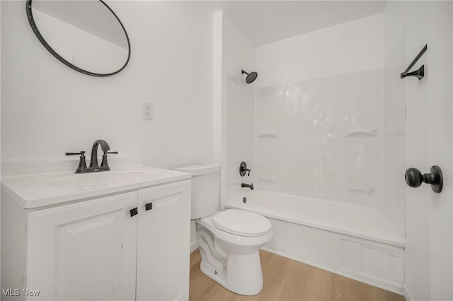 full bathroom with vanity, hardwood / wood-style floors, shower / bathtub combination, and toilet