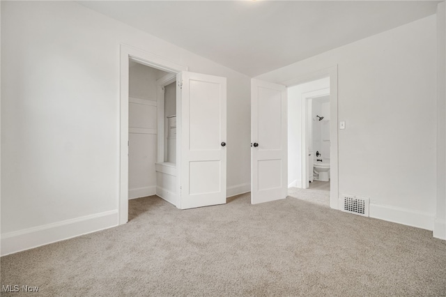 unfurnished bedroom with light colored carpet