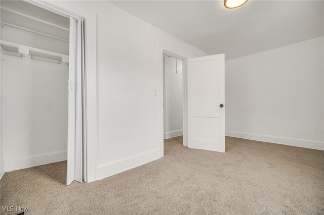 unfurnished bedroom with carpet floors and a closet