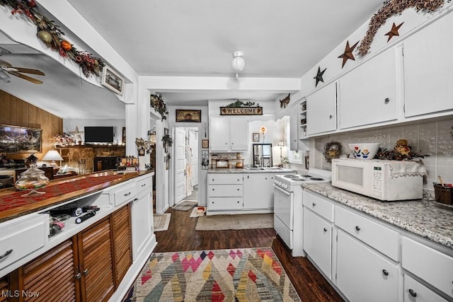 kitchen with white appliances, dark hardwood / wood-style floors, and white cabinets