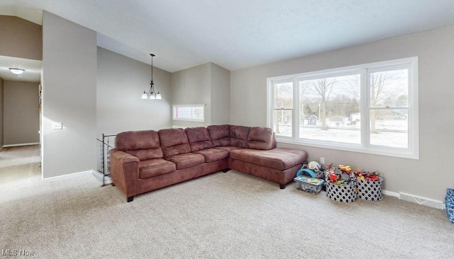 living room featuring lofted ceiling, a chandelier, and carpet